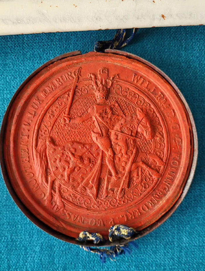 Red wax seal on historic document linked to stolen historic documents used as collateral a decade ago. Red wax seal on historic document linked to stolen historic documents used as collateral a decade ago.