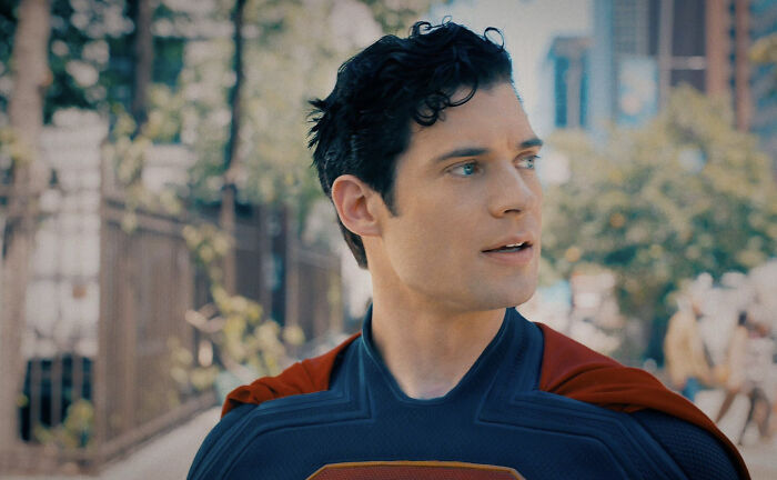 Superman reboot actor in costume outdoors, reflecting the woke Superman reboot amid early negative critic reviews.