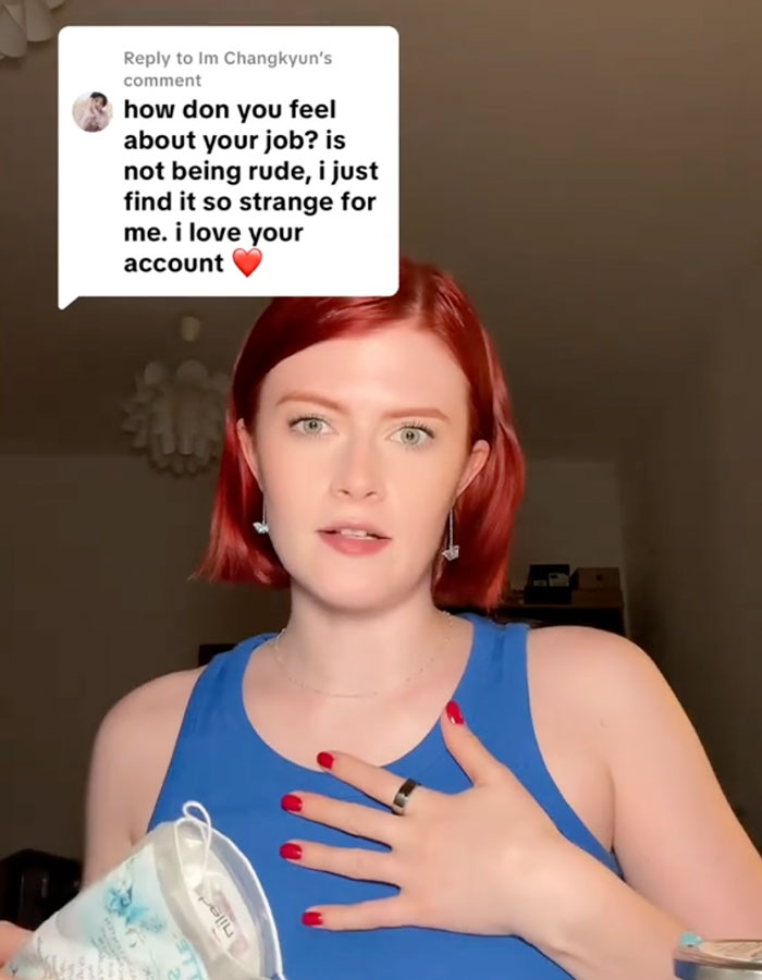 Young woman in a blue top responding to comment, discussing racial discrimination faced by professional escorts in the industry.