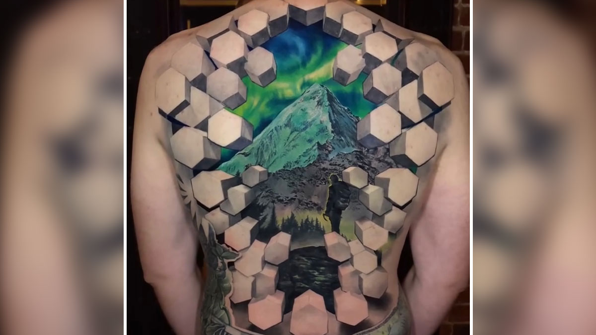 3D tattoos by Jesse Rix on a back featuring a mountain scene with geometric shapes creating a portal effect.