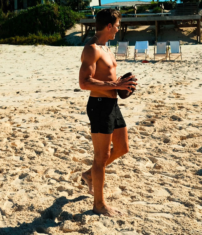 Shirtless man playing with a football on a sunny beach, capturing summer romance and spice vibes outdoors. Shirtless man playing with a football on a sunny beach, capturing summer romance and spice vibes outdoors.