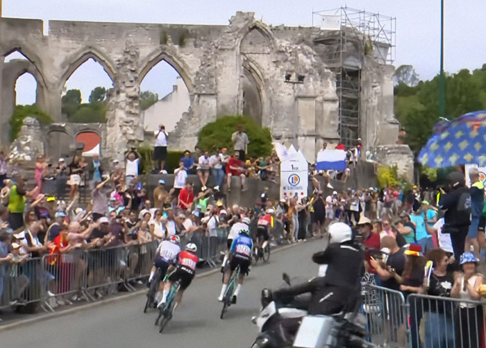 Tour De France fans crowd the roadside and stand on graves at a historic site to get a better view of the race. Tour De France fans crowd the roadside and stand on graves at a historic site to get a better view of the race.