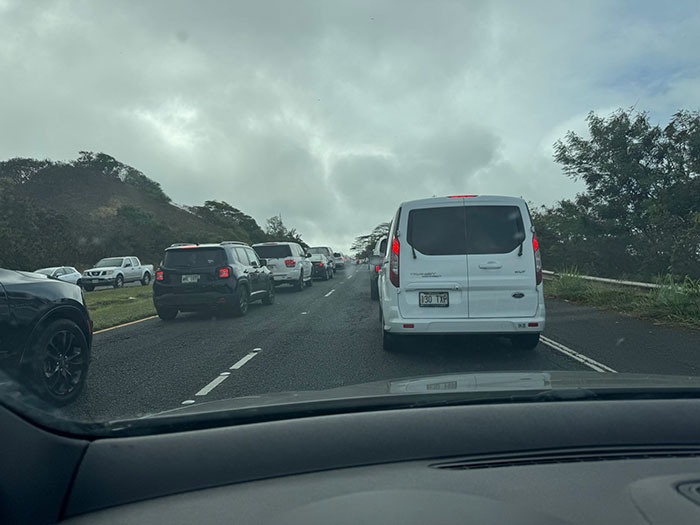 Traffic jam on a narrow road with cars stuck, illustrating a private road blocking escape from an oncoming tsunami. Traffic jam on a narrow road with cars stuck, illustrating a private road blocking escape from an oncoming tsunami.