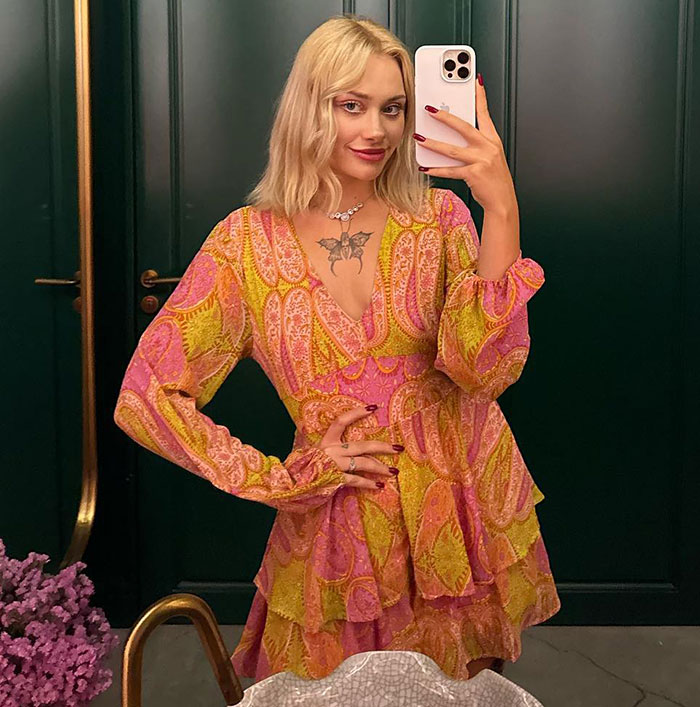 Model taking a mirror selfie wearing a colorful dress, related to model found with broken limbs and spine in Dubai case. Model taking a mirror selfie wearing a colorful dress, related to model found with broken limbs and spine in Dubai case.