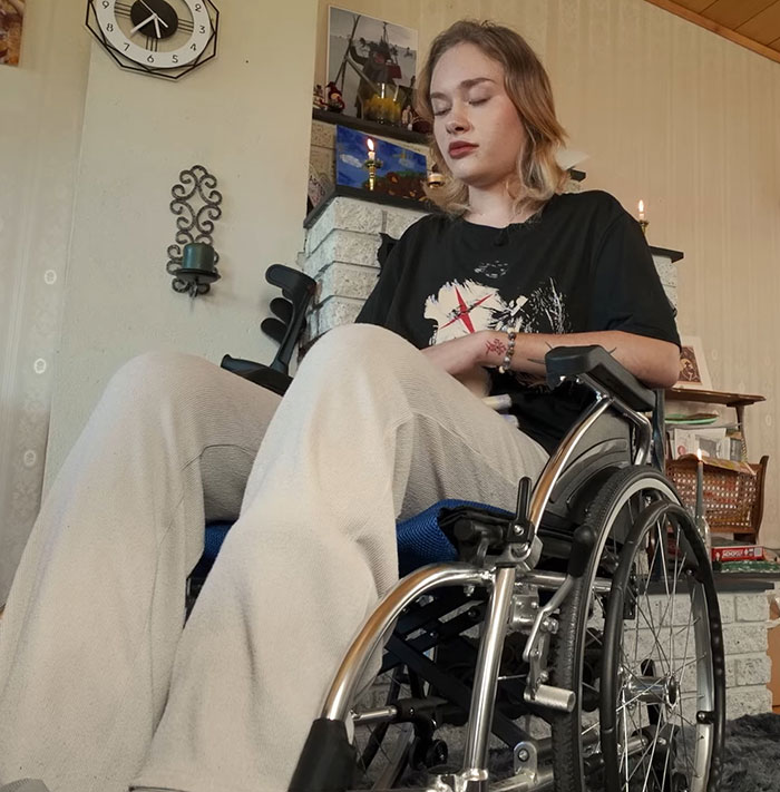 Young model with broken limbs and spine sitting in a wheelchair indoors, recovering after roadside incident in Dubai. Young model with broken limbs and spine sitting in a wheelchair indoors, recovering after roadside incident in Dubai.