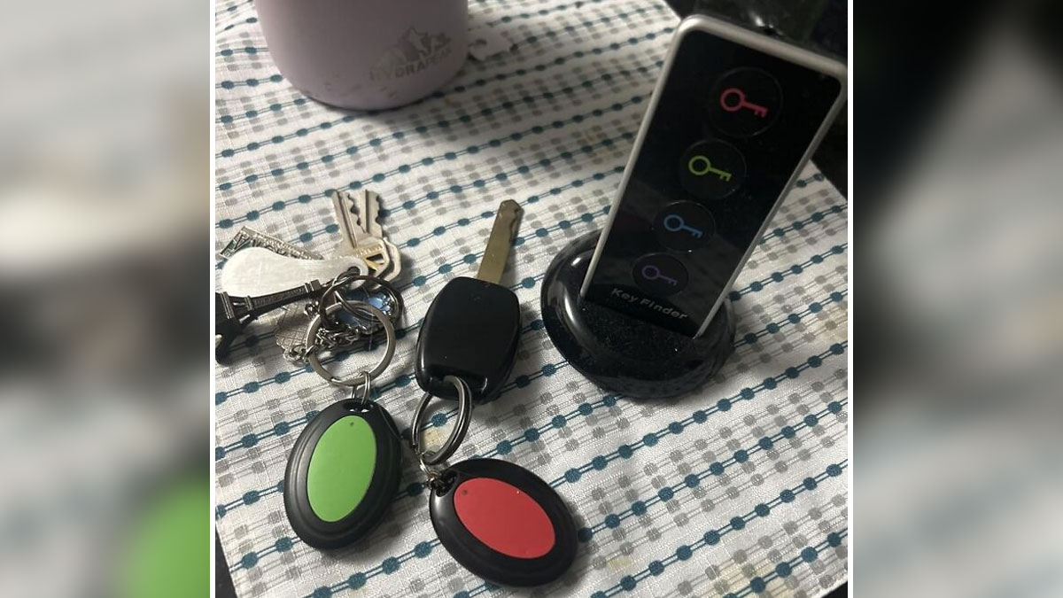 Key finder device with colored buttons beside a set of keys on a patterned tablecloth showing internet's best kept secrets.