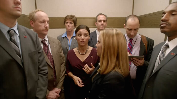 Several characters from popular shows looking tense and uncomfortable in a crowded elevator, highlighting hard to love characters.