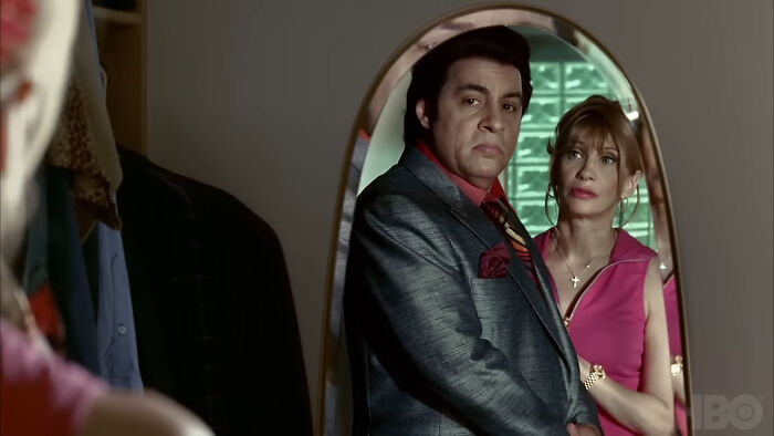 Two characters with complex personalities stand in front of a mirror, representing shows with hard to love characters.