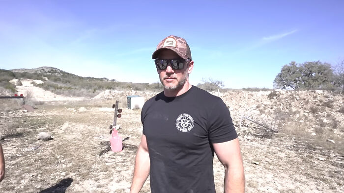 Man wearing sunglasses and a cap outdoors in a dry landscape, relating to people share unsubscribed YouTubers.