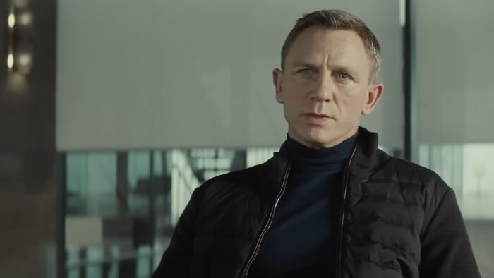 Man in black jacket and turtleneck indoors, representing celebrities many people love but honestly can't stand.