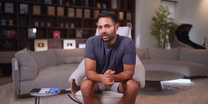 Man in casual clothes sitting in a modern living room, sharing thoughts about people who unsubscribed from YouTubers.