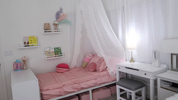 Cozy pink bedroom with canopy bed, plush toys, and organized shelves illustrating trends leading to overconsumption.