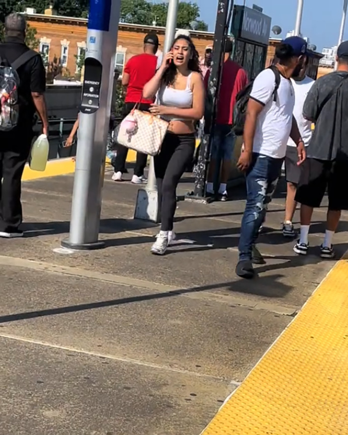 Woman on subway platform speaking on phone while men deliver vigilante justice after attack in viral video. Woman on subway platform speaking on phone while men deliver vigilante justice after attack in viral video.