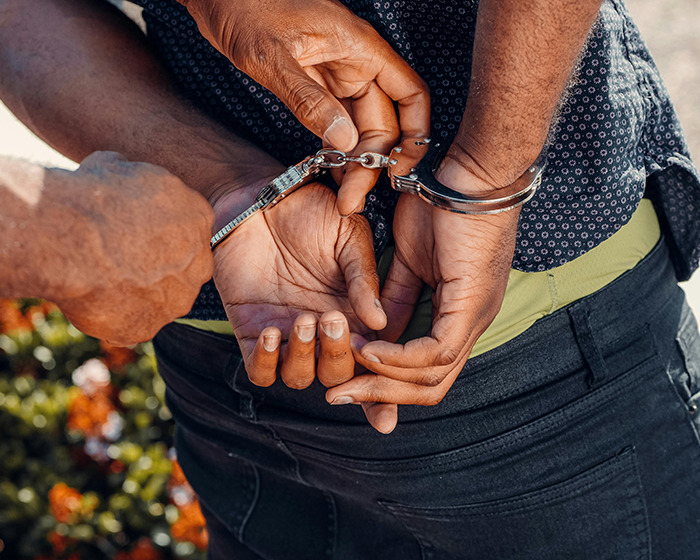 Man being handcuffed by police after men deliver vigilante justice following assault on subway platform. Man being handcuffed by police after men deliver vigilante justice following assault on subway platform.