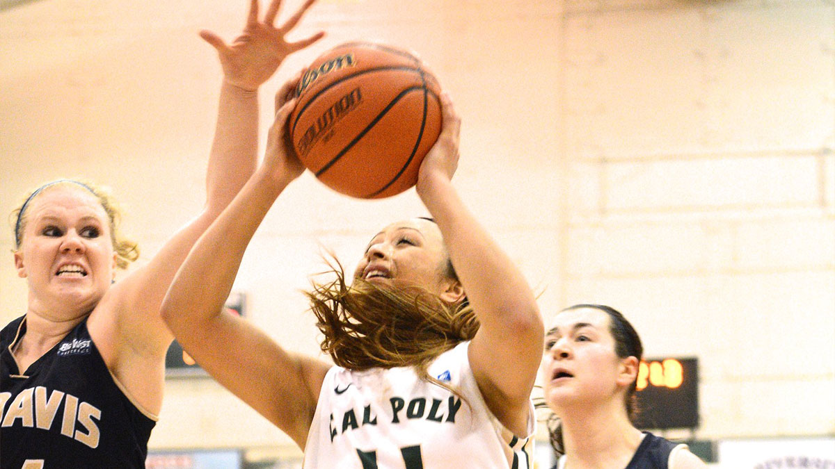 Female basketball players competing intensely, highlighting strength and determination in feminist daily wins.