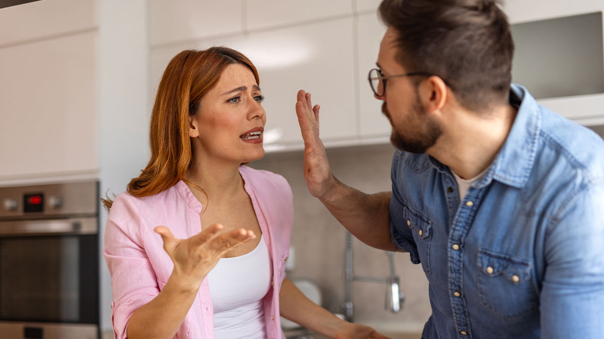 Woman begging friend to cut off guy after petty conflict, showing emotional tension between them in a kitchen setting