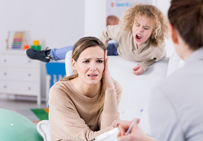 Stressed woman dealing with friend’s rowdy kids, deciding to host only childfree events in the future. Stressed woman dealing with friend’s rowdy kids, deciding to host only childfree events in the future.