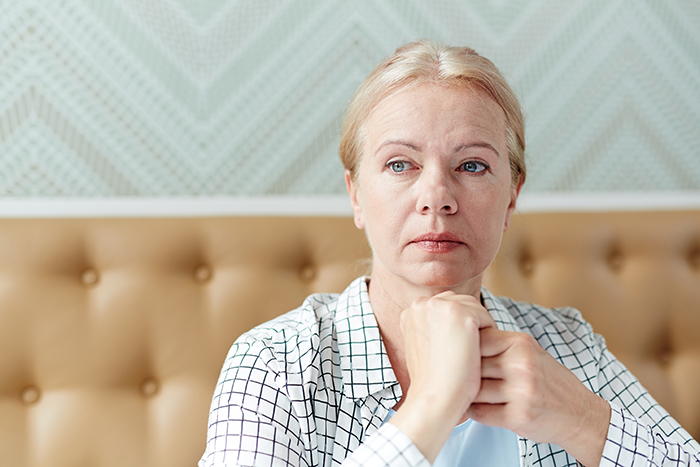 Woman looking shocked and thoughtful, reflecting emotions after discovering mother-in-law's hatred following husband's death Woman looking shocked and thoughtful, reflecting emotions after discovering mother-in-law's hatred following husband's death