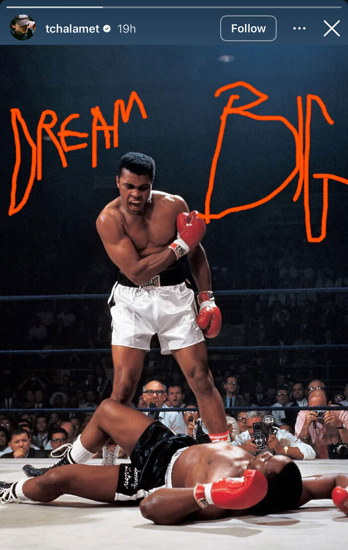 Boxer celebrating victory in ring with crowd and photographers around, text dream big in bold orange letters Boxer celebrating victory in ring with crowd and photographers around, text dream big in bold orange letters