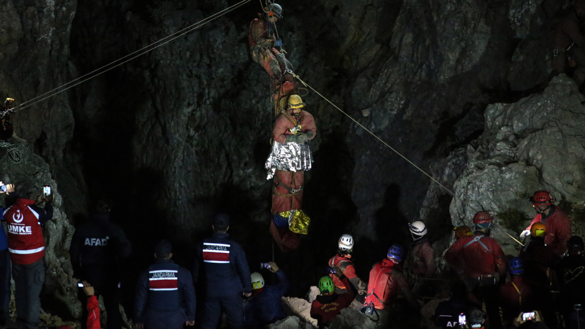 Rescue team performing cave rescue at night, highlighting real-life claustrophobia challenges in tight spaces.