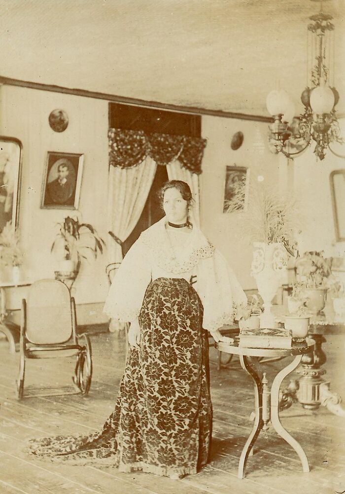Woman in traditional attire standing in an elegant room, showcasing lifestyle in the Philippines in the 1890s.