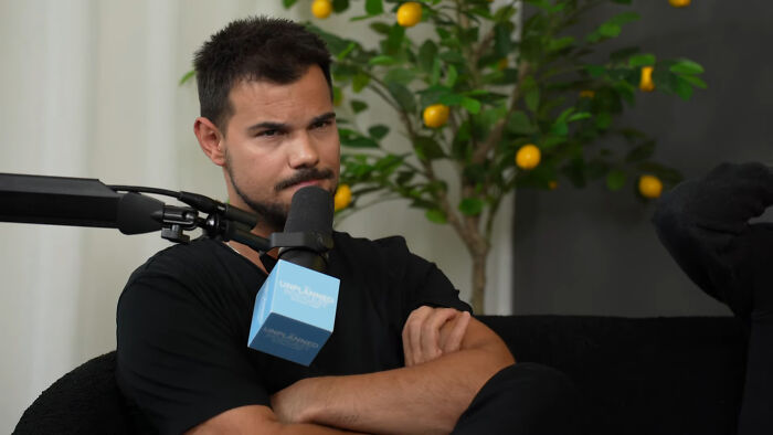 Man speaking into a microphone during a podcast recording about celebrities Hollywood tried to make leading A-listers.