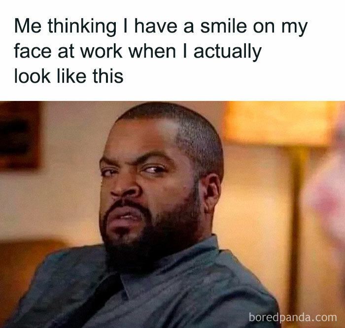 Man with a skeptical expression representing introvert-worthy memes about awkward smiles at work.