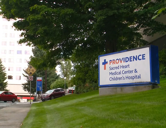 Providence Sacred Heart Medical Center entrance with sign, related to hospital firing 15 nurses after patient suicide. Providence Sacred Heart Medical Center entrance with sign, related to hospital firing 15 nurses after patient suicide.