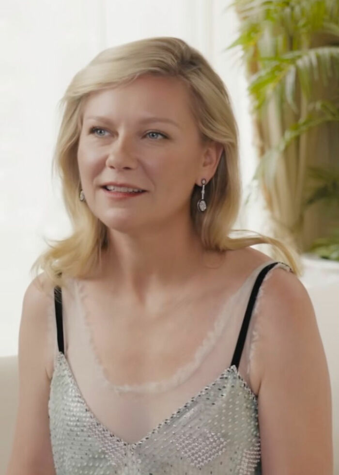 Kirsten Dunst speaking in an indoor setting, sharing the correct pronunciation of her name with a calm expression. Kirsten Dunst speaking in an indoor setting, sharing the correct pronunciation of her name with a calm expression.