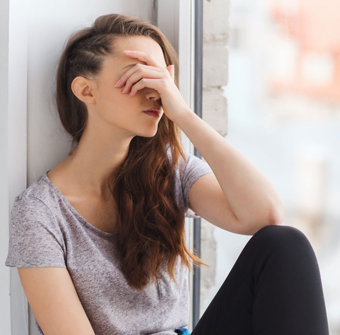 Woman sitting by a window looking frustrated as man tells wife she couldn’t do it without him, watching her prove him wrong