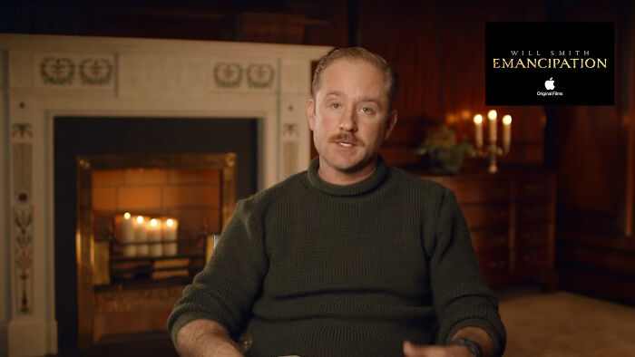Man in a green sweater sitting by a fireplace, representing celebrities Hollywood tried to make leading A-listers.