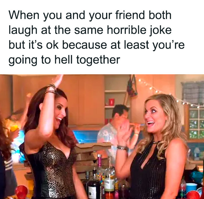 Two women laughing and high-fiving over a horrible joke, showcasing relatable friendship memes humor and connection.