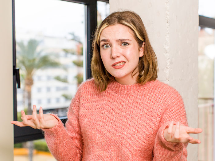 Woman in a pink sweater wondering if she should explain that separation and divorce are not the same to her husband Woman in a pink sweater wondering if she should explain that separation and divorce are not the same to her husband