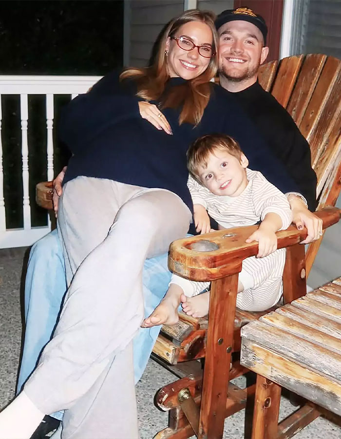 A smiling family sitting on wooden chairs, representing momfluencer taking full accountability after tragic drowning in home pool. A smiling family sitting on wooden chairs, representing momfluencer taking full accountability after tragic drowning in home pool.