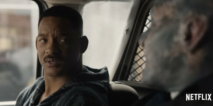 Scene from a Netflix movie featuring two men in a car, reflecting on disappointing Netflix movies in a dramatic moment.