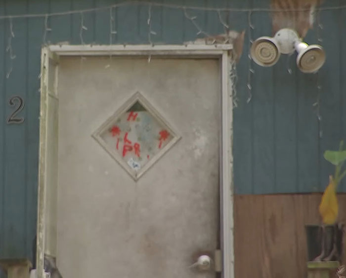 Old weathered door of a Florida home where mother abandoned her child and seven dogs during vacation. Old weathered door of a Florida home where mother abandoned her child and seven dogs during vacation.