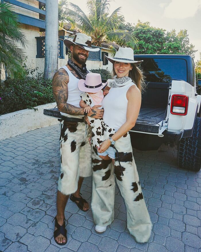 Singer wearing cowboy outfits with family outside near a vehicle, highlighting a concert moment involving an irresponsible mom. Singer wearing cowboy outfits with family outside near a vehicle, highlighting a concert moment involving an irresponsible mom.