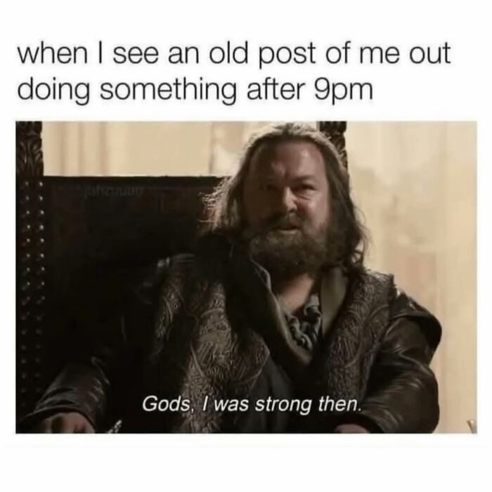 Man with beard sitting in a chair captioned funny parenting meme about strength after 9pm in parenting life.
