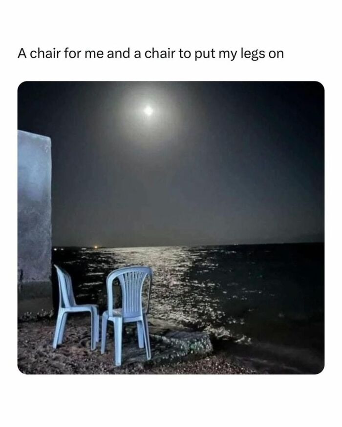 Two plastic chairs by a moonlit ocean shore, humorously captioned as one chair for sitting and one for resting legs meme.