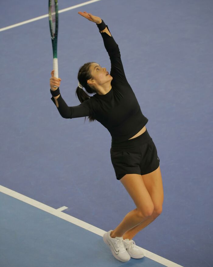 Tennis star serving during a match, showing intense focus amid diva issues involving a sudden meltdown on court. Tennis star serving during a match, showing intense focus amid diva issues involving a sudden meltdown on court.