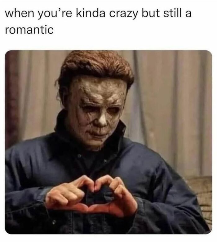 Creepy but funny meme of a masked character making a heart shape with hands, blending humor and dark themes.