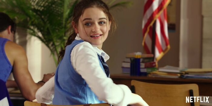 Young woman smiling in a classroom setting, representing Netflix movies that turned out to be total letdowns.
