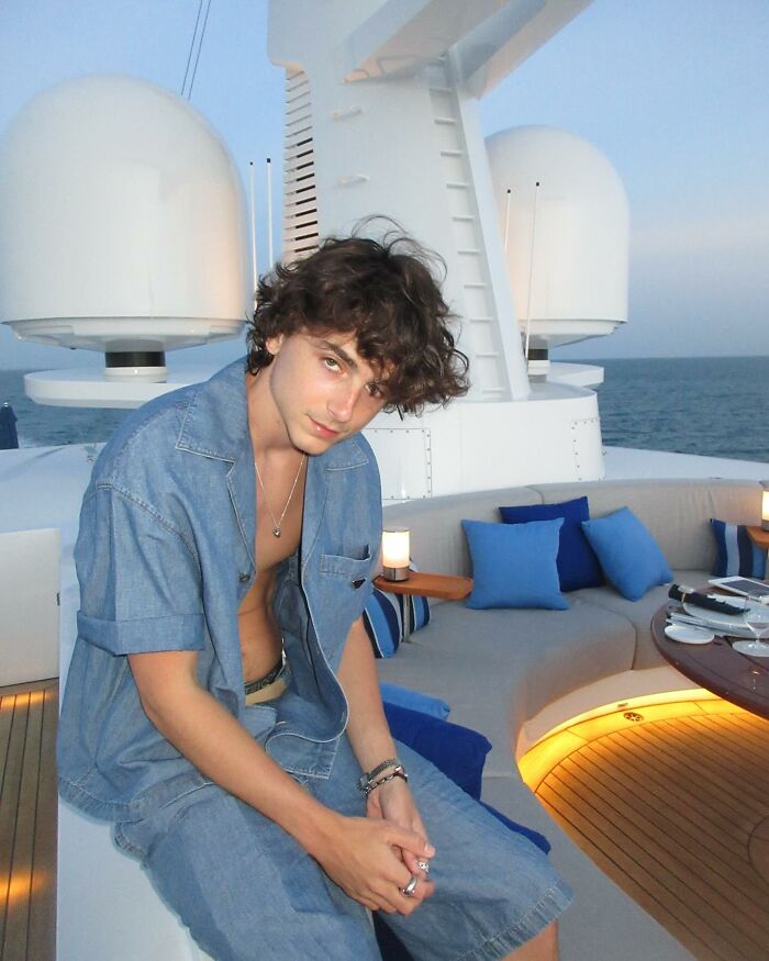 Timothée Chalamet sitting on a yacht deck wearing denim, sharing a bizarre post on Kylie Jenner’s birthday. Timothée Chalamet sitting on a yacht deck wearing denim, sharing a bizarre post on Kylie Jenner’s birthday.