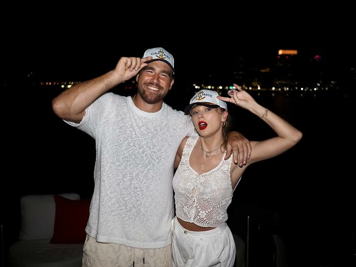 Travis Kelce and Taylor Swift smiling and posing together at night, sparking buzz involving Kayla Nicole. Travis Kelce and Taylor Swift smiling and posing together at night, sparking buzz involving Kayla Nicole.