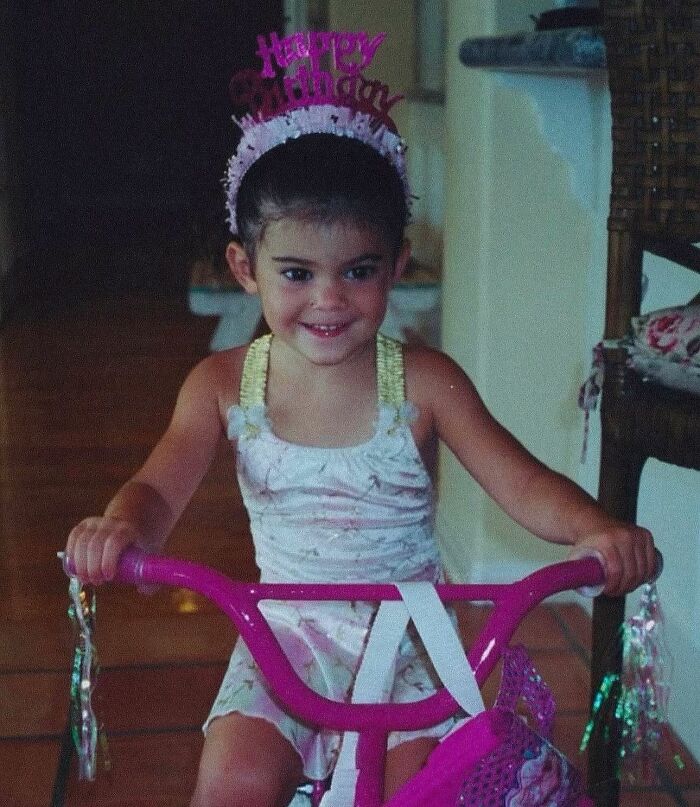 Young girl celebrating birthday riding a pink bike, related to Timothée Chalamet and Kylie Jenner birthday post. Young girl celebrating birthday riding a pink bike, related to Timothée Chalamet and Kylie Jenner birthday post.