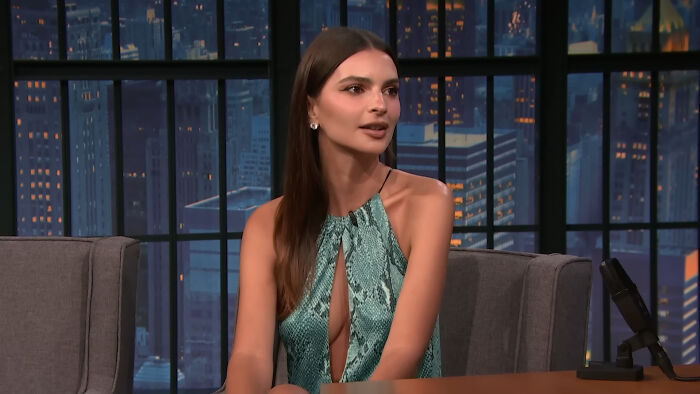 Celebrity wearing a green dress on a late-night talk show set, representing celebrities Hollywood tried to make leading A-listers.