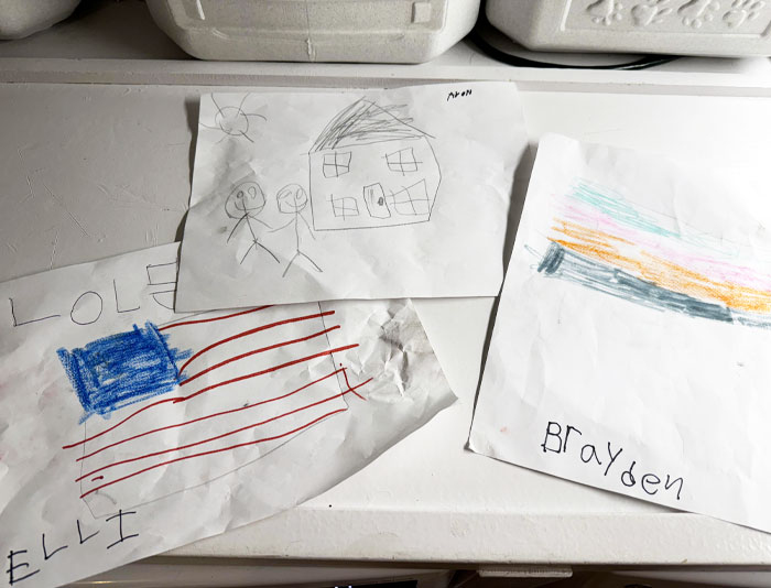 Children's drawings of a house, flag, and colorful abstract lines, reflecting wholesome kind neighbors and community spirit. Children's drawings of a house, flag, and colorful abstract lines, reflecting wholesome kind neighbors and community spirit.