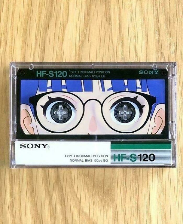 Cassette tape with creative design featuring a cartoon face with glasses and detailed eyes, showcasing smart and cool design.
