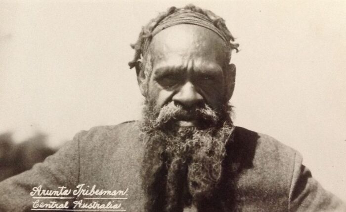 Indigenous Australian elder with a long beard wearing traditional headband in a rare early 1900s historic photograph.