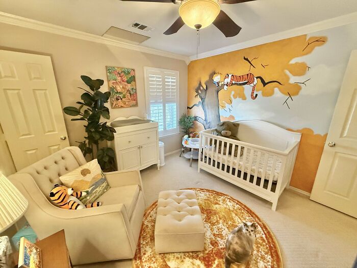Cozy baby nursery corner decorated with a mural and plush toys, showcasing home decoration pride.